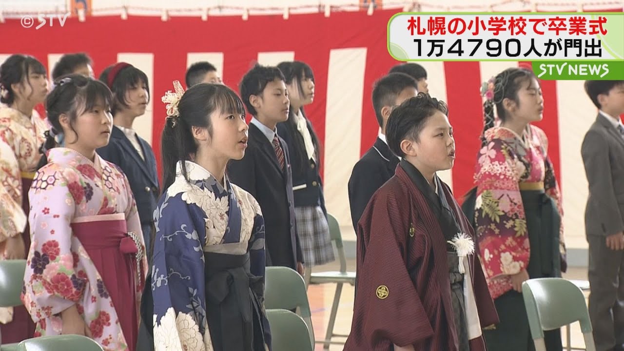 Dressed in gorgeous hakama and suits, students leave their