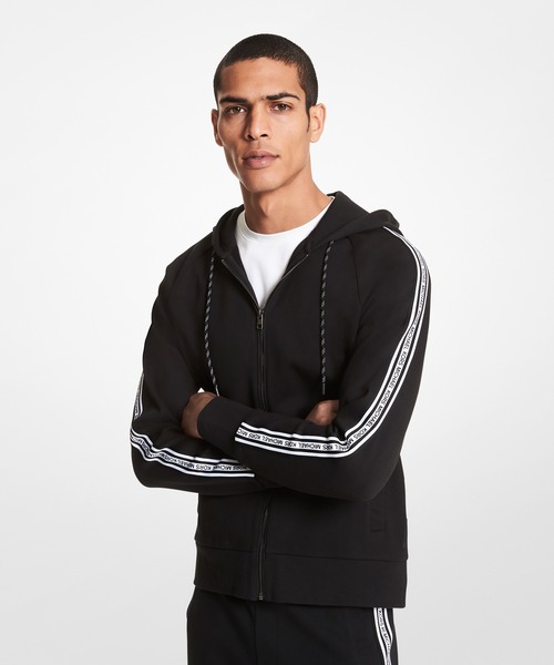 MICHAEL KORS（マイケルコース）の「ロゴテープ ジップフーディー